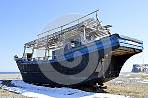 Abandoned North Korean fishing schooner on the shore of the Sea of â€ÂÃ‚Ââ€¹â€ÂÃ‚Ââ€¹Japan, Primorye, Russia.